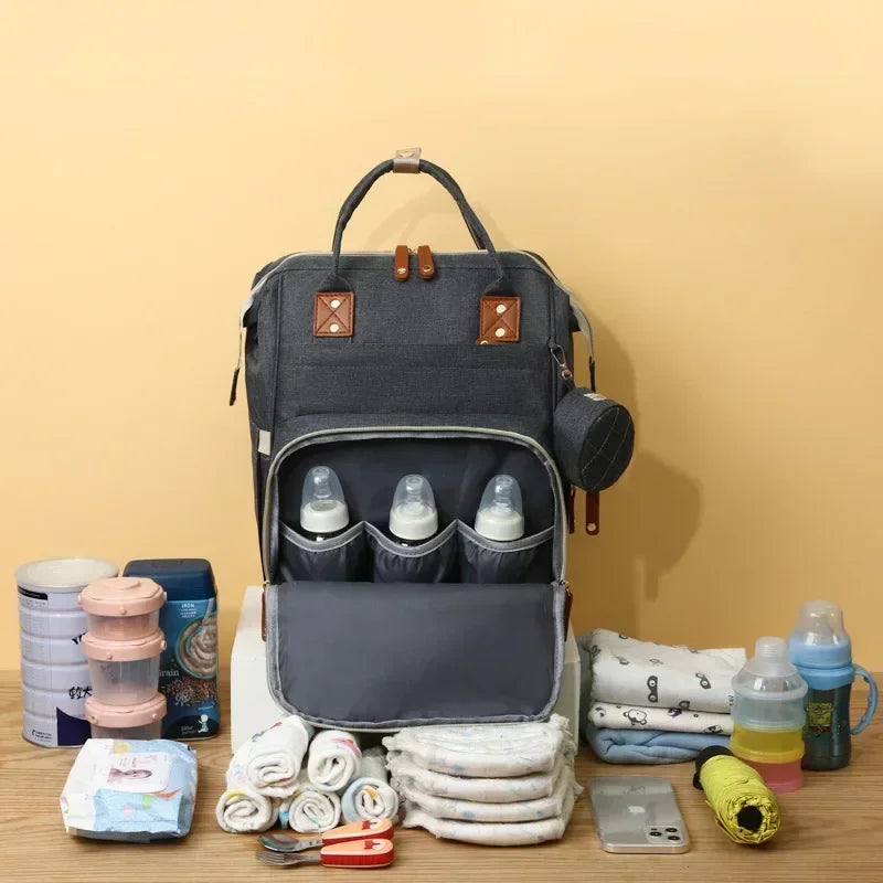 Sac à Dos à Langer pour bébé, Sac de Voyage avec Lit de Bébé Portable, 35L Grande Capacité Sac de Maternité, Sac à Couches Multifonction avec 2 Sangles de Poussette et Berceau