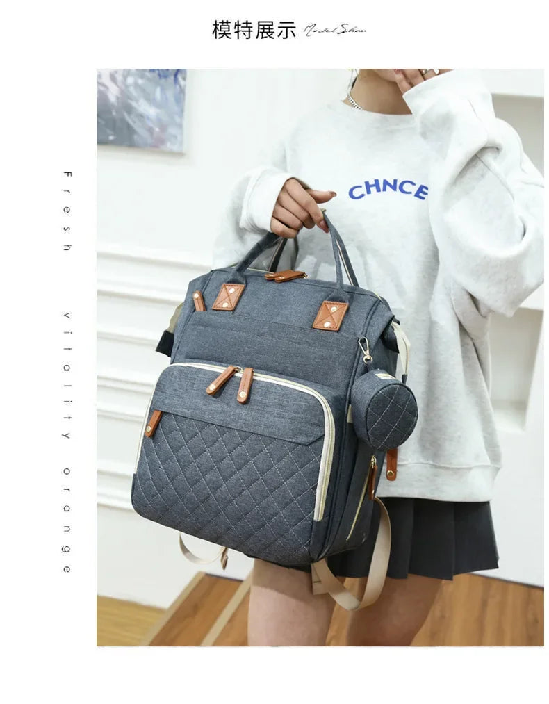 Sac à Dos à Langer pour bébé, Sac de Voyage avec Lit de Bébé Portable, 35L Grande Capacité Sac de Maternité, Sac à Couches Multifonction avec 2 Sangles de Poussette et Berceau