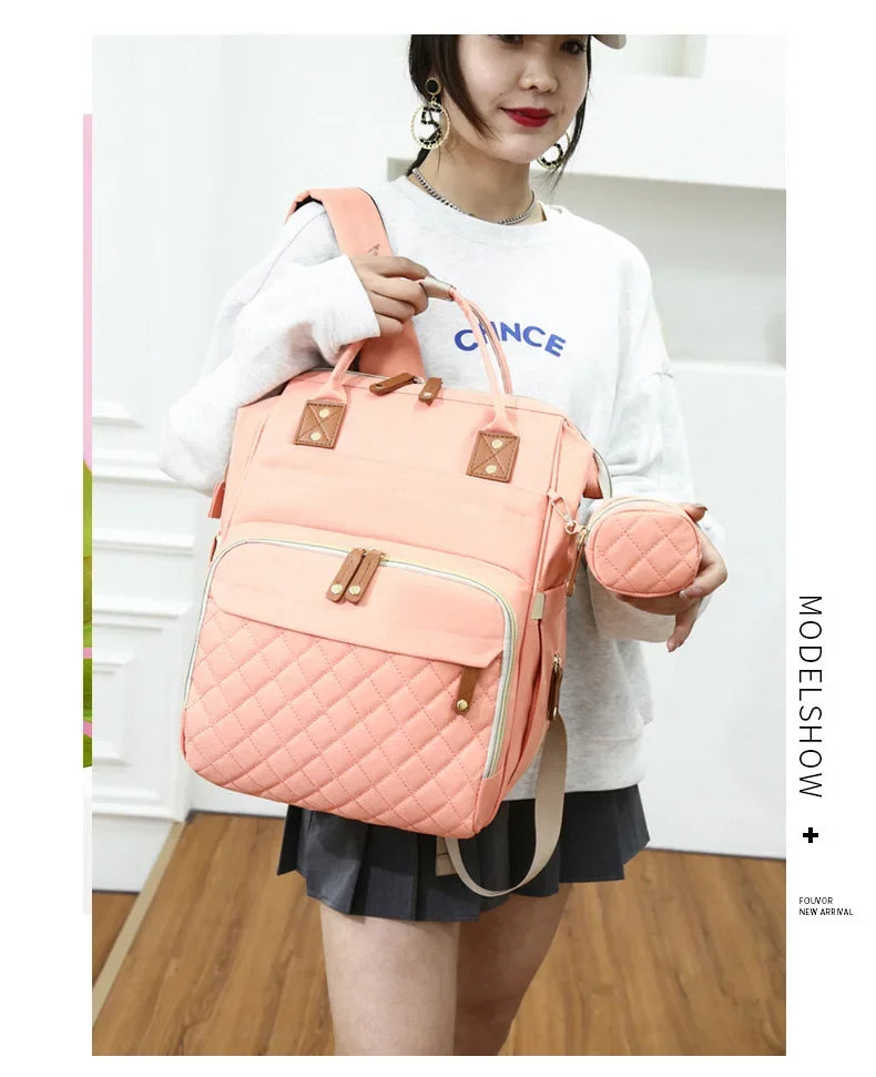 Sac à Dos à Langer pour bébé, Sac de Voyage avec Lit de Bébé Portable, 35L Grande Capacité Sac de Maternité, Sac à Couches Multifonction avec 2 Sangles, Rose